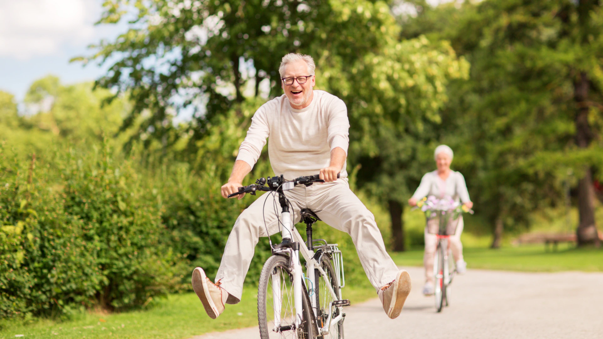 happy old couple riding their bikes